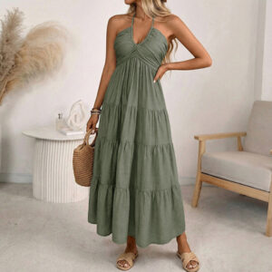 Solid-color halter-neck vacation-style loose maxi dress with a stylish open back and smocked detailing.